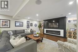 Entertainment area featuring a built-in media wall with a wide linear fireplace - 