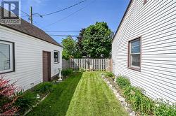 Manicured lawn area with a privacy fence. - 