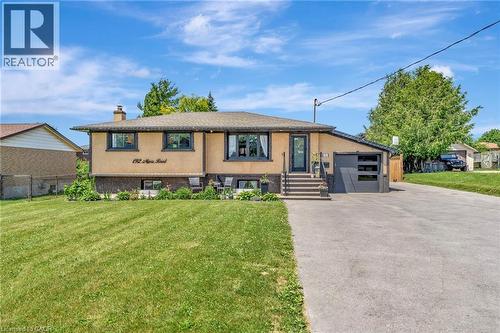 Split-level residence featuring a stucco and stone facade with dark trim windows - 192 Myers Road, Cambridge, ON 