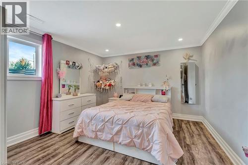 Recessed lighting illuminates this space featuring wood-finish flooring and crown molding - 192 Myers Road, Cambridge, ON 