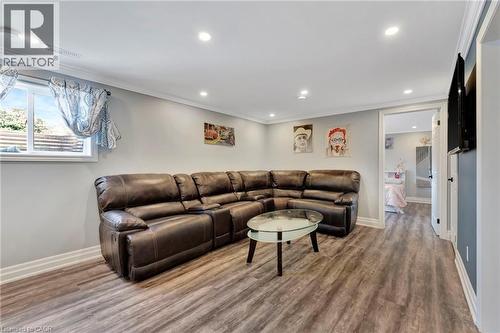 Spacious room with wood-finish flooring, recessed lighting, and crown molding - 192 Myers Road, Cambridge, ON 