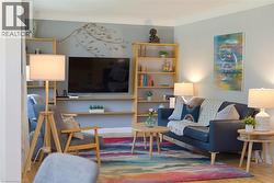 Integrated shelving and media center with light wood-finish construction - 