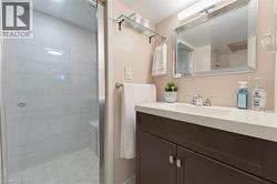 Contemporary bathroom featuring a frameless glass shower enclosure with large format wall tiles, a built-in shower bench, and a coordinating tiled shower floor - 