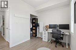 Light-toned wood-finish flooring complements white walls and trim - 