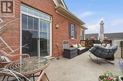 Expansive concrete patio area with a red brick exterior - 