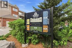 Community site plan display board surrounded by established landscaping - 