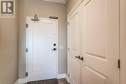 White panel doors with dark bronze hardware complement light beige walls and white trim - 