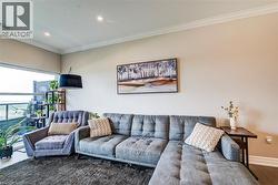 Open concept living area with crown molding and recessed lighting - 