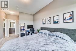Carpeted bedroom featuring a vaulted ceiling and a neutral color palette - 