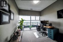 Expansive window wall with sliding door access to an exterior balcony - 