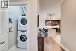 Dedicated laundry closet featuring a stacked washer and dryer - 