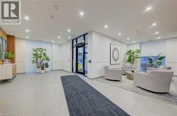 Contemporary common area featuring recessed lighting, paneled accent walls, and large format tile flooring - 