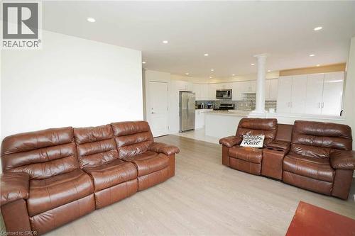 Open-concept living space featuring wood-finish flooring and recessed lighting - 187 Adler Drive, Cambridge, ON - Indoor Photo Showing Living Room