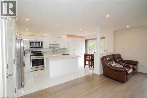 Bright kitchen featuring white cabinetry, stainless steel appliances, a center island with countertop, and recessed lighting - 187 Adler Drive, Cambridge, ON - Indoor Photo Showing Kitchen With Upgraded Kitchen