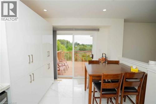 Dining space featuring white tile flooring and extensive white built-in cabinetry - 187 Adler Drive, Cambridge, ON - Indoor Photo Showing Dining Room