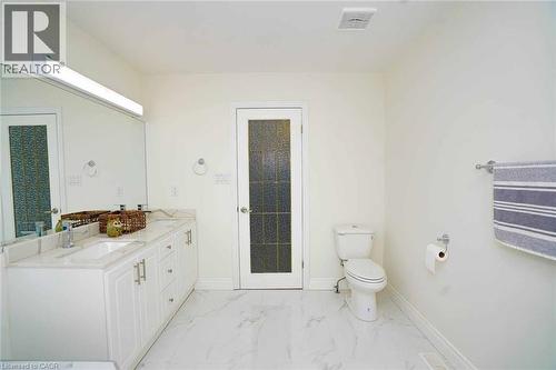 Bathroom featuring a double vanity with white cabinetry, light-colored countertops, and integrated sinks - 187 Adler Drive, Cambridge, ON - Indoor Photo Showing Bathroom