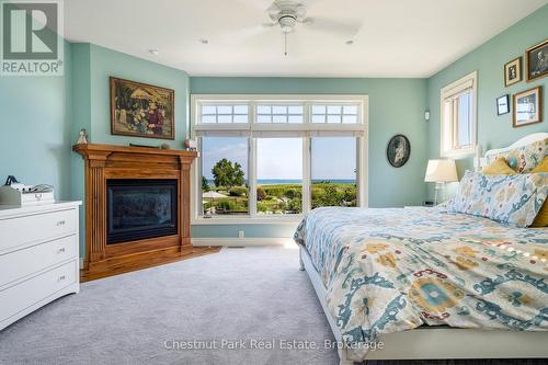 Primary bedroom with gas fireplace & view to pool - 176 Bartlett Boulevard, Collingwood, ON 