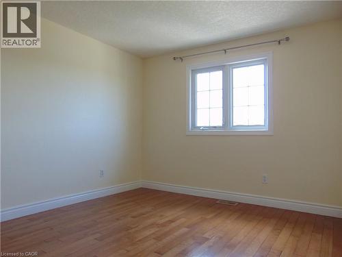 Room featuring light-colored walls and wood-finish flooring - 214 Snowdrop Crescent, Kitchener, ON 