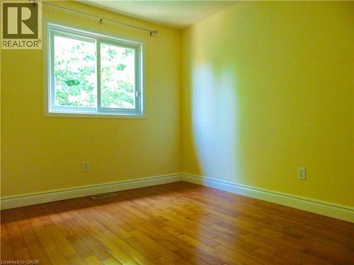 Hardwood flooring and a large sliding window with a window casing - 214 Snowdrop Crescent, Kitchener, ON 