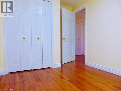 Warm wood-finish flooring complements light wall tones - 214 Snowdrop Crescent, Kitchener, ON 