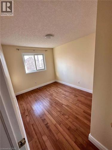 Bedroom featuring wood-finish flooring. - 214 Snowdrop Crescent, Kitchener, ON 