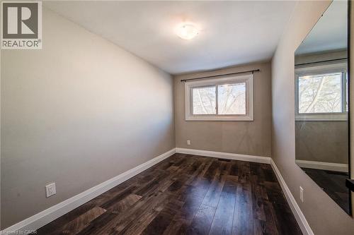 Room featuring dark wood-finish flooring and light-toned walls - 415-435 Garden Street Unit# 421, Cambridge, ON 