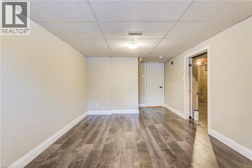 Finished room featuring wood-finish flooring, light-toned walls, and a drop ceiling - 415-435 Garden Street Unit# 421, Cambridge, ON 