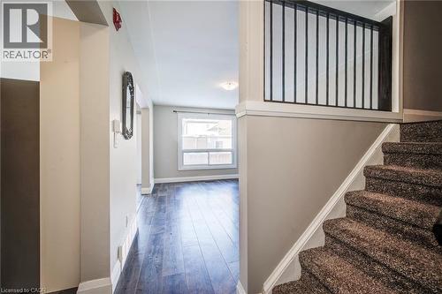 Carpeted staircase with white trim and a black metal balustrade - 415-435 Garden Street Unit# 421, Cambridge, ON 