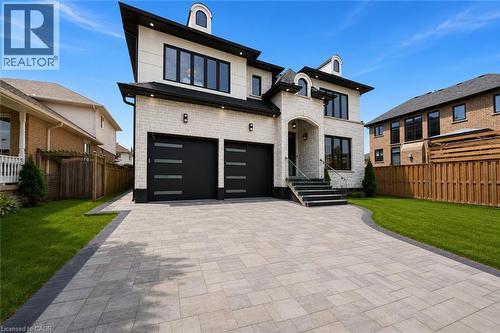 Modern two-story residence featuring light-colored brick and dark trim - 62 Jeremy Street, Hamilton, ON 