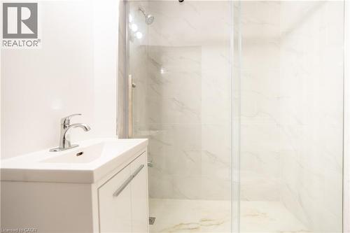 White vanity with an integrated sink and chrome faucet - 1274 Barton Street E, Hamilton, ON 