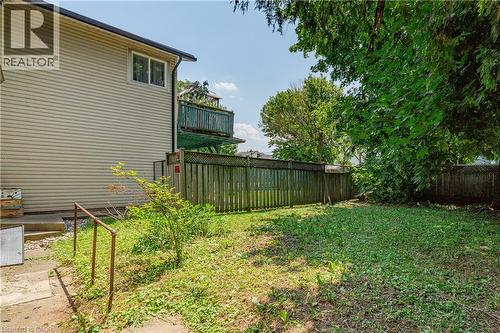 Expansive grassy yard with wood fencing and mature trees - 1274 Barton Street E, Hamilton, ON 