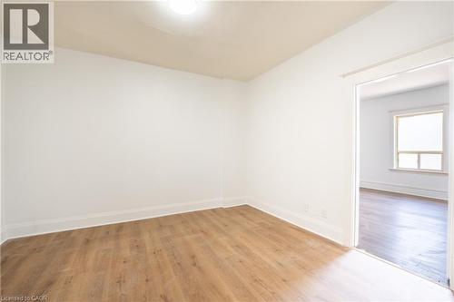 Bright interior space featuring wood-finish flooring, white baseboards, and a neutral wall palette - 1274 Barton Street E, Hamilton, ON 