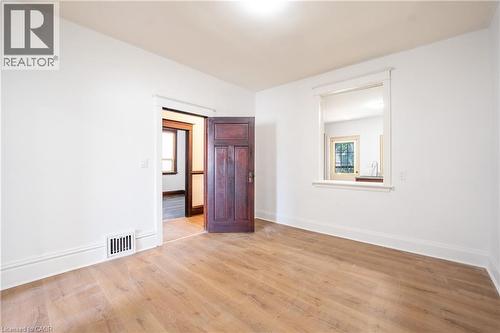 Room with wood-finish flooring, white walls, and bright white trim - 1274 Barton Street E, Hamilton, ON 