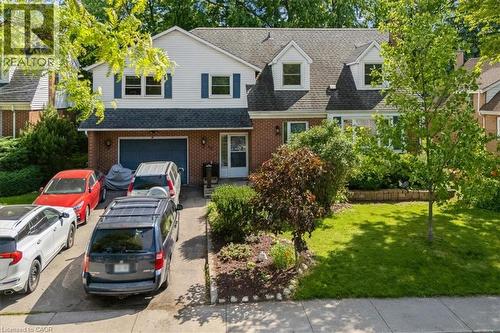Brick and siding exterior featuring a prominent two-car garage with a blue door - 80 Maclennan Avenue, Hamilton, ON - Outdoor