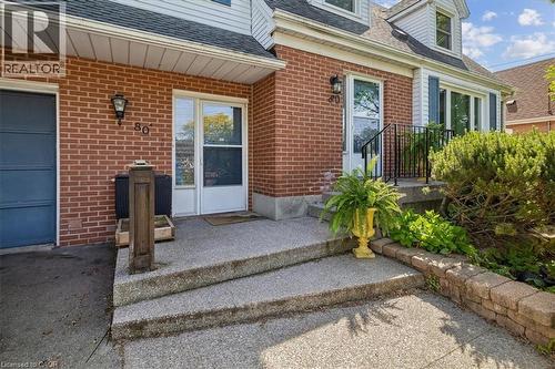Brick exterior with white siding accents and a black shingle roof - 80 Maclennan Avenue, Hamilton, ON - Outdoor With Exterior