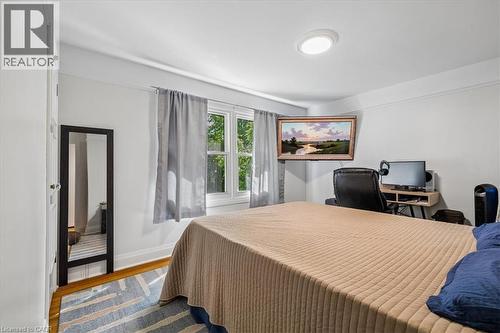 Bright interior space featuring a window with natural light, wood-finish flooring, and white painted walls - 80 Maclennan Avenue, Hamilton, ON - Indoor Photo Showing Bedroom