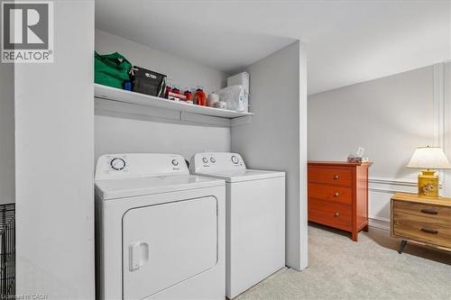 Dedicated laundry area featuring a washer and dryer set with an overhead storage shelf - 80 Maclennan Avenue, Hamilton, ON - Indoor Photo Showing Laundry Room
