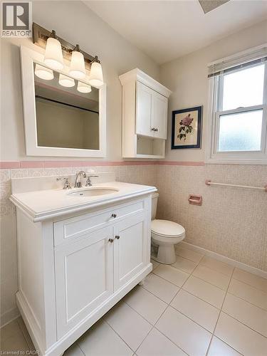 White vanity with an integrated sink and chrome fixtures - 80 Maclennan Avenue, Hamilton, ON - Indoor Photo Showing Bathroom