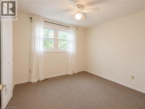 Neutral wall palette, window with exterior landscape, ceiling fan with integrated lighting, and carpeted flooring - 80 Maclennan Avenue, Hamilton, ON - Indoor Photo Showing Other Room