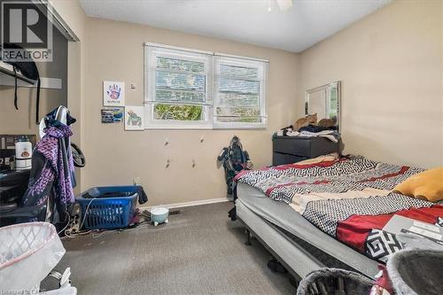 Bedroom featuring neutral wall paint, carpet flooring, a ceiling fan, and two windows with blinds - 80 Maclennan Avenue, Hamilton, ON 