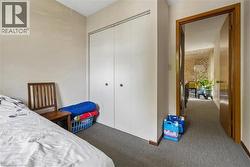 Bedroom featuring neutral wall paint and gray carpet flooring - 