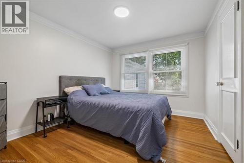 Bedroom featuring wood-finish flooring, white baseboards, and crown molding - 80 Maclennan Avenue, Hamilton, ON - Indoor Photo Showing Bedroom