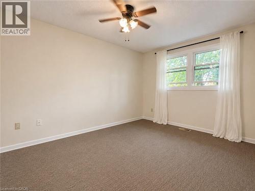 Neutral wall paint, ceiling fan, broad window, and wall-to-wall carpeting - 80 Maclennan Avenue, Hamilton, ON - Indoor Photo Showing Other Room