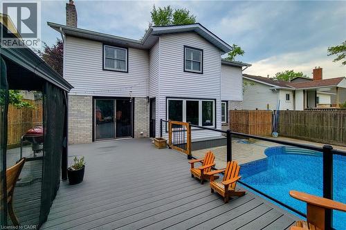 Multi-level composite deck with glass panel railing and an inground swimming pool - 29 Woodside Square, Fonthill, ON - Outdoor With In Ground Pool With Deck Patio Veranda With Exterior