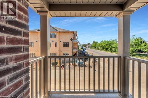 Balcony featuring a durable railing system and a textured brick exterior wall - 19 Picardy Drive Unit# 9, Hamilton, ON 
