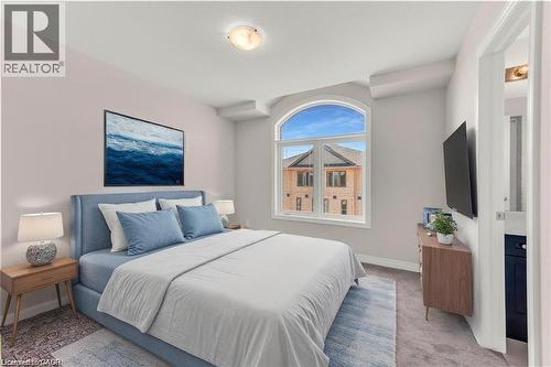 Room featuring an arched window, soft gray wall paint, and recessed ceiling details - 19 Picardy Drive Unit# 9, Hamilton, ON 