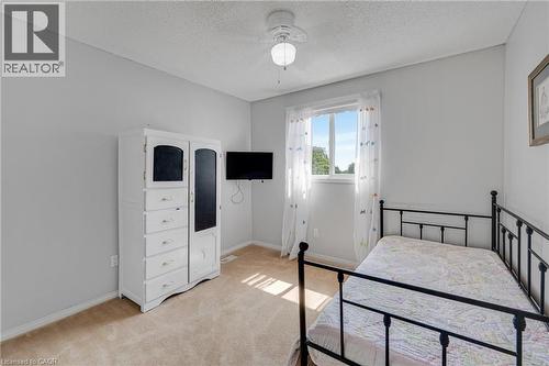 Neutral tone wall paint, light tan carpeting, and a window with white trim - 409 Jacqueline Boulevard, Hamilton, ON 