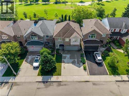 Two-story brick and stone exterior with a two-car garage and a paved driveway - 409 Jacqueline Boulevard, Hamilton, ON 
