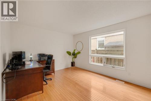 Bright room featuring light wood-finish flooring, white walls, and a large window providing natural light - 409 Jacqueline Boulevard, Hamilton, ON 