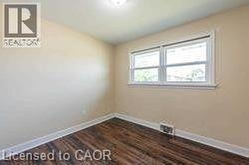 Light-filled interior space featuring wood-finish flooring, neutral wall tones, and white trim - 10 Collier Road, Thorold, ON 